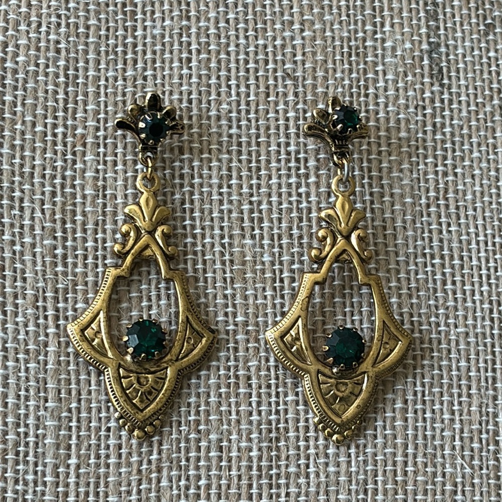 Vintage gold toned ornate drop dangle pierced earrings with green rhinestones.
